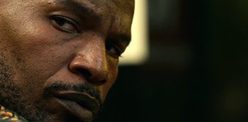 Movie still from “Project Power” (2020), directed by Henry Joost – A man's face with dirt all over it; Extreme Close Up shot, Low angle