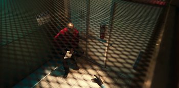 Movie still from “Project Power” (2020), directed by Henry Joost – A man standing in front of an open door; Wide shot, Overhead angle