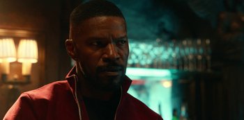 Movie still from “Project Power” (2020), directed by Henry Joost – A person wearing a red jacket; Close Up shot, Over the shoulder angle