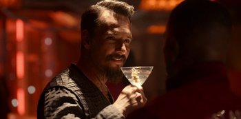 Movie still from “Project Power” (2020), directed by Henry Joost – A man holding a glass in his hand; Close Up shot, Over the shoulder angle