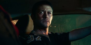 Movie still from “Project Power” (2020), directed by Henry Joost – A person sitting in a car; Close Up shot, Low angle