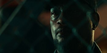 Movie still from “Project Power” (2020), directed by Henry Joost – A man's face in the dark; Extreme Close Up shot, Low angle