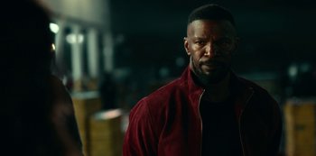 Movie still from “Project Power” (2020), directed by Henry Joost – A person wearing a red jacket; Close Up shot, Over the shoulder angle