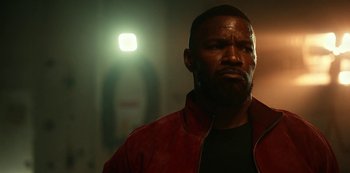 Movie still from “Project Power” (2020), directed by Henry Joost – A person wearing a red jacket; Close Up shot, Low angle