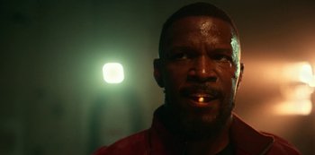 Movie still from “Project Power” (2020), directed by Henry Joost – A person with a light in the background; Close Up shot, Low angle