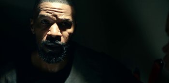 Movie still from “Project Power” (2020), directed by Henry Joost – A person with a beard; Close Up shot, Low angle