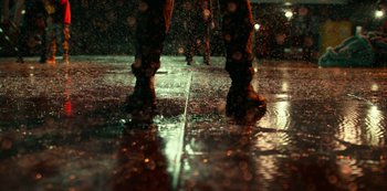 Movie still from “Project Power” (2020), directed by Henry Joost – A person walking in the rain; Wide shot, Low angle