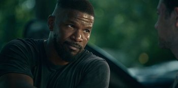 Movie still from “Project Power” (2020), directed by Henry Joost – A person wearing a black shirt; Close Up shot, Over the shoulder angle