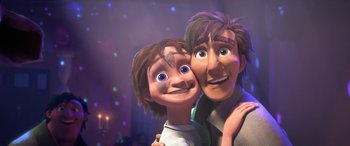 Movie still from “Puss in Boots: The Last Wish” (2022), directed by Januel Mercado – A man and a boy are smiling for the camera; Close Up shot, Low angle