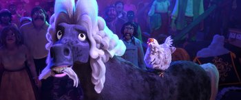 Movie still from “Puss in Boots: The Last Wish” (2022), directed by Januel Mercado – A rooster is sitting next to an animal in a crowd of people; Close Up shot, Low angle