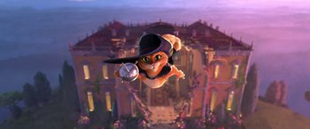 Movie still from “Puss in Boots: The Last Wish” (2022), directed by Januel Mercado – An animated cat flying through the air with a hat on its head; Wide shot, Low angle