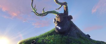 Movie still from “Puss in Boots: The Last Wish” (2022), directed by Januel Mercado – An artistic rendering of a tree with a face on top of it; Wide shot, Low angle