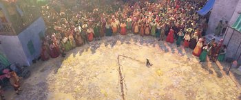 Movie still from “Puss in Boots: The Last Wish” (2022), directed by Januel Mercado – A crowd of people standing around a circle; Extreme Wide shot, Overhead angle
