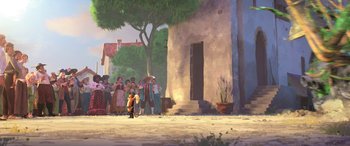 Movie still from “Puss in Boots: The Last Wish” (2022), directed by Januel Mercado – A group of people standing in front of a building; Extreme Wide shot, Low angle