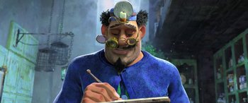 Movie still from “Puss in Boots: The Last Wish” (2022), directed by Januel Mercado – A man with glasses and a beard writing on a piece of paper; Medium shot, Low angle