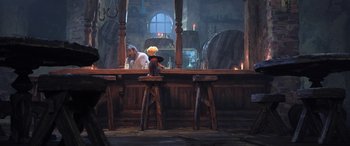 Movie still from “Puss in Boots: The Last Wish” (2022), directed by Januel Mercado – A man sitting at a bar; Wide shot, Over the shoulder angle