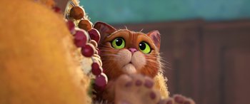 Movie still from “Puss in Boots: The Last Wish” (2022), directed by Januel Mercado – The head of a cat with green eyes; Close Up shot, Low angle