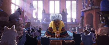 Movie still from “Puss in Boots: The Last Wish” (2022), directed by Januel Mercado – An image of a woman with many cats in a room; Wide shot, Low angle