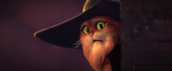 Movie still from “Puss in Boots: The Last Wish” (2022), directed by Januel Mercado – An orange cat wearing a black witch's hat; Close Up shot, Low angle