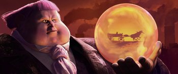 Movie still from “Puss in Boots: The Last Wish” (2022), directed by Januel Mercado – An image of a man holding a crystal ball; Close Up shot, Low angle