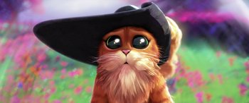 Movie still from “Puss in Boots: The Last Wish” (2022), directed by Januel Mercado – An orange cat wearing a black hat with a flower background; Close Up shot, Low angle