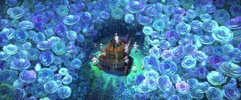 Movie still from “Puss in Boots: The Last Wish” (2022), directed by Januel Mercado – An artistic rendering of a house surrounded by blue flowers; Extreme Wide shot, High angle