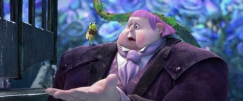 Movie still from “Puss in Boots: The Last Wish” (2022), directed by Januel Mercado – A man in a purple suit with a bug on his shoulder; Medium shot, Over the shoulder angle