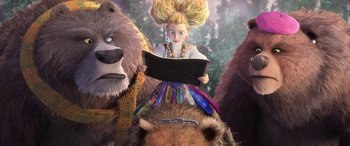 Movie still from “Puss in Boots: The Last Wish” (2022), directed by Januel Mercado – A woman is reading a book in front of a group of bears; Medium shot, Low angle