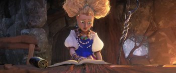 Movie still from “Puss in Boots: The Last Wish” (2022), directed by Januel Mercado – A woman is reading an open book in a scene from a cartoon; Medium shot, Over the shoulder angle