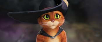 Movie still from “Puss in Boots: The Last Wish” (2022), directed by Januel Mercado – An orange and white cat wearing a black hat; Close Up shot, High angle