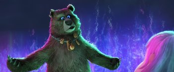 Movie still from “Puss in Boots: The Last Wish” (2022), directed by Januel Mercado – A green teddy bear wearing a chain around its neck; Close Up shot, Low angle