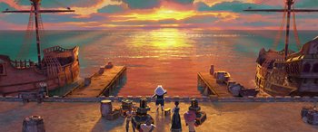 Movie still from “Puss in Boots: The Last Wish” (2022), directed by Januel Mercado – A group of people standing on a dock near the ocean; Extreme Wide shot, High angle