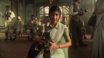 A woman is holding a camera and taking a picture