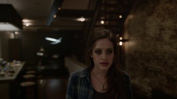 Movie still from “Mr. Robot” (2015), created by Sam Esmail – A young woman with dark hair wearing a plaid shirt; Close Up shot, High angle