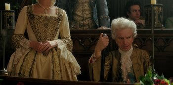 Movie still from “Queen Charlotte: A Bridgerton Story” (2023), directed by Tom Verica – A man and a woman dressed in period clothing; Medium shot, High angle