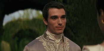 Movie still from “Queen Charlotte: A Bridgerton Story” (2023), directed by Tom Verica – A person wearing a suit and tie; Close Up shot, Over the shoulder angle