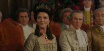 Movie still from “Queen Charlotte: A Bridgerton Story” (2023), directed by Tom Verica – A person wearing a dress and a crown; Close Up shot, Over the shoulder angle