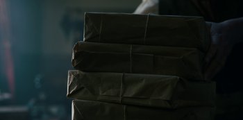 Movie still from “Queen Charlotte: A Bridgerton Story” (2023), directed by Tom Verica – A stack of brown paper bags sitting on top of each other; Extreme Close Up shot, Low angle
