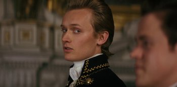 Movie still from “Queen Charlotte: A Bridgerton Story” (2023), directed by Tom Verica – A person wearing a suit; Close Up shot, Low angle