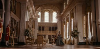 Movie still from “Queen Charlotte: A Bridgerton Story” (2023), directed by Tom Verica – A woman in a dress in a large room; Extreme Wide shot, Low angle
