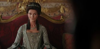 Movie still from “Queen Charlotte: A Bridgerton Story” (2023), directed by Tom Verica – An older woman wearing a dress and a crown; Close Up shot, Low angle