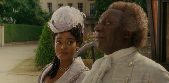 Movie still from “Queen Charlotte: A Bridgerton Story” (2023), directed by Tom Verica – A man and a woman dressed in period clothing; Close Up shot, Low angle