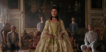 Movie still from “Queen Charlotte: A Bridgerton Story” (2023), directed by Tom Verica – A woman dressed in period clothing holding a knife; Medium shot, Low angle