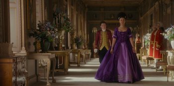 Movie still from “Queen Charlotte: A Bridgerton Story” (2023), directed by Tom Verica – A man and a woman dressed up in formal wear; Wide shot, Low angle