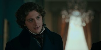 Movie still from “Queen Charlotte: A Bridgerton Story” (2023), directed by Tom Verica – A man in a black coat and a red bow tie; Close Up shot, Over the shoulder angle