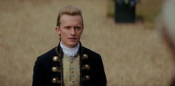 Movie still from “Queen Charlotte: A Bridgerton Story” (2023), directed by Tom Verica – A man in a black jacket and white shirt; Close Up shot, Low angle