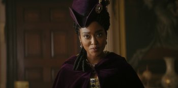 Movie still from “Queen Charlotte: A Bridgerton Story” (2023), directed by Tom Verica – A woman wearing a purple hat and a purple cape; Close Up shot, Low angle