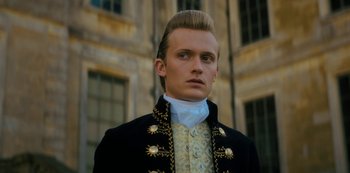 Movie still from “Queen Charlotte: A Bridgerton Story” (2023), directed by Tom Verica – A man in a black jacket and a white shirt; Close Up shot, Low angle