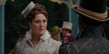 Movie still from “Queen Charlotte: A Bridgerton Story” (2023), directed by Tom Verica – An older woman wearing a hat and a fur collar; Close Up shot, Over the shoulder angle