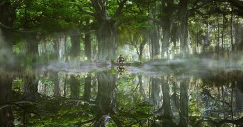 A person standing in a forest near a body of water
